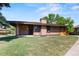 Charming single story house with a covered porch and lush green lawn at 3720 S Fairplay Way, Aurora, CO 80014