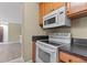 Well-equipped kitchen with black countertops and modern appliances, perfect for cooking at 3720 S Fairplay Way, Aurora, CO 80014