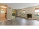 Inviting living room with wood floors, a cozy fireplace, and access to the patio at 3720 S Fairplay Way, Aurora, CO 80014