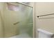 A well-maintained shower featuring sliding glass doors and handrails at 3720 S Fairplay Way, Aurora, CO 80014