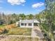 Aerial view of a single-story home, fenced yard, and long driveway at 7760 Magnolia St, Commerce City, CO 80022
