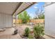 Covered patio with brick-paved area, metal tubs, and a fenced yard at 7760 Magnolia St, Commerce City, CO 80022