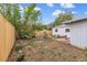 Spacious backyard with a wooden fence and metal stock tank planters at 7760 Magnolia St, Commerce City, CO 80022