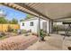 Cozy backyard with a covered patio, brick pavers, and a metal tub at 7760 Magnolia St, Commerce City, CO 80022