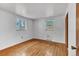 Bright bedroom with hardwood floors and natural light from two windows at 7760 Magnolia St, Commerce City, CO 80022