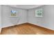 Bright bedroom with hardwood floors and natural light from two windows at 7760 Magnolia St, Commerce City, CO 80022