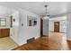 Open dining area featuring hardwood floors, a chandelier, and seamless transition to other living spaces at 7760 Magnolia St, Commerce City, CO 80022