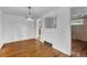 Elegant dining room with hardwood floors, a decorative chandelier, and an adjacent mirror on the wall at 7760 Magnolia St, Commerce City, CO 80022