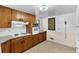 Traditional kitchen with wood cabinets, tiled backsplash, and integrated oven appliance at 7760 Magnolia St, Commerce City, CO 80022