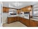 Traditional kitchen with wood cabinets, tiled backsplash, and integrated oven appliance at 7760 Magnolia St, Commerce City, CO 80022