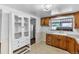 Traditional kitchen with wood cabinets, tile backsplash, and bright natural light at 7760 Magnolia St, Commerce City, CO 80022