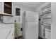 Functional laundry room with washer, dryer, and refrigerator near the back door at 7760 Magnolia St, Commerce City, CO 80022