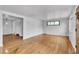 Spacious living room featuring hardwood floors, neutral paint, a modern window, and ample natural light at 7760 Magnolia St, Commerce City, CO 80022