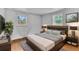 Nicely staged main bedroom with hardwood floors, and modern décor with neutral colors at 7760 Magnolia St, Commerce City, CO 80022