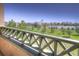 Balcony overlooking a well-maintained green space and parking area, ideal for enjoying outdoor views at 11932 W Long Cir # 202, Littleton, CO 80127