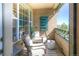 Cozy balcony with comfortable chairs, plants, and a view of the outdoors, perfect for relaxing and enjoying the fresh air at 11932 W Long Cir # 202, Littleton, CO 80127