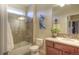 Stylish bathroom featuring a vanity, modern mirror, and tiled glass-enclosed shower-tub at 11932 W Long Cir # 202, Littleton, CO 80127
