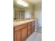 Elegant bathroom featuring double sinks, modern fixtures, wood cabinets, and a large mirror providing a luxurious feel at 11932 W Long Cir # 202, Littleton, CO 80127