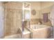 Modern bathroom features a tiled shower, a soaking tub, and stylish fixtures creating a spa-like ambiance at 11932 W Long Cir # 202, Littleton, CO 80127