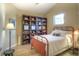 Vaulted bedroom featuring a window, wood floors, a red metal bed frame and a large shelving unit at 11932 W Long Cir # 202, Littleton, CO 80127