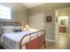 Bright bedroom with a view to an ensuite bathroom, light colored walls, and wood flooring at 11932 W Long Cir # 202, Littleton, CO 80127