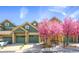 Charming home with a well-maintained yard, complemented by vibrant flowering trees and attached garages at 11932 W Long Cir # 202, Littleton, CO 80127