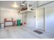 Spacious garage featuring ample storage, organization, and clean epoxy floors, ideal for vehicles and projects at 11932 W Long Cir # 202, Littleton, CO 80127