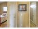 Hallway view into a bedroom showcasing neutral walls, artwork, and modern lighting throughout the home at 11932 W Long Cir # 202, Littleton, CO 80127