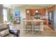 Well-equipped kitchen with stainless steel appliances, granite countertops, and an adjacent dining area at 11932 W Long Cir # 202, Littleton, CO 80127
