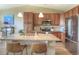 Contemporary kitchen with stainless steel appliances, granite countertops, and a convenient breakfast bar at 11932 W Long Cir # 202, Littleton, CO 80127