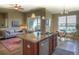 Open-concept living area features a kitchen island with granite countertops, stainless steel appliances, and lots of natural light at 11932 W Long Cir # 202, Littleton, CO 80127