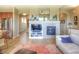 Bright living room showcasing an elegant fireplace, sleek stainless steel refrigerator, and open floor plan at 11932 W Long Cir # 202, Littleton, CO 80127