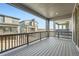 Scenic balcony with wooden decking and metal railings, offering views of neighboring homes and landscape at 3172 S Russell St, Morrison, CO 80465
