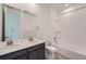 Modern bathroom featuring double sinks, a sleek vanity, tiled floors, and a shower-tub combo at 3172 S Russell St, Morrison, CO 80465