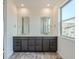 Bathroom with double vanity, gray cabinets, large mirrors, and modern finishes at 3172 S Russell St, Morrison, CO 80465
