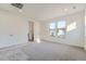Bright bedroom featuring neutral carpet, ample natural light, and two closets at 3172 S Russell St, Morrison, CO 80465