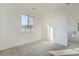 Minimalist bedroom with neutral carpet, natural light, and white walls at 3172 S Russell St, Morrison, CO 80465