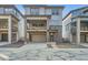 Modern two-story townhome with a gray exterior, a balcony, a two-car garage, and brick accents at 3172 S Russell St, Morrison, CO 80465