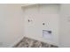 Functional laundry room with tile flooring, connections for washer/dryer, and ample space for storage at 3172 S Russell St, Morrison, CO 80465
