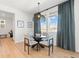 Bright dining room with glass table and four chairs, offering a view at 3589 Rucksack Ct, Castle Rock, CO 80108