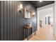 Modern entryway with dark shiplap accent wall, wood-toned console table, and light wood flooring at 3589 Rucksack Ct, Castle Rock, CO 80108