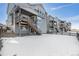 Townhouse exterior with snowy backyard and deck at 3589 Rucksack Ct, Castle Rock, CO 80108