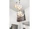 Bright foyer with a dramatic three-light geometric chandelier at 3589 Rucksack Ct, Castle Rock, CO 80108