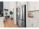 Kitchen with stainless steel refrigerator and white cabinetry at 3589 Rucksack Ct, Castle Rock, CO 80108