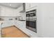 Modern kitchen with double oven and white cabinetry at 3589 Rucksack Ct, Castle Rock, CO 80108