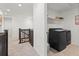 Upper-level laundry room with washer and dryer, and built-in shelving at 3589 Rucksack Ct, Castle Rock, CO 80108