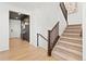 Modern staircase with dark wood railing and carpeted steps at 3589 Rucksack Ct, Castle Rock, CO 80108