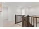 Upstairs hallway with dark wood railings and carpet at 3589 Rucksack Ct, Castle Rock, CO 80108