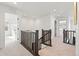 Upstairs hallway with dark wood railings and carpet at 3589 Rucksack Ct, Castle Rock, CO 80108