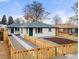 Front view of a home with a walkway, gravel and wood fence at 3311 Jasmine St, Denver, CO 80207